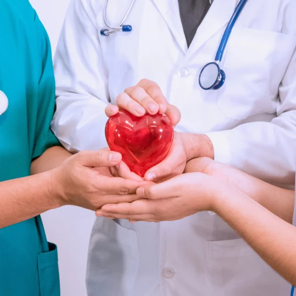 close-up-group-doctor-nurse-hands-holding-red-heart-together-patient-care-treatment-concerns-concept-scaled
