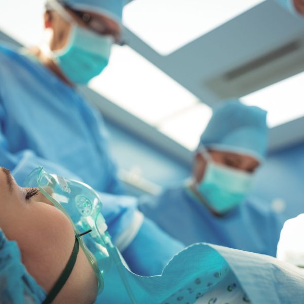 Team of surgeons performing operation in operation theater at hospital